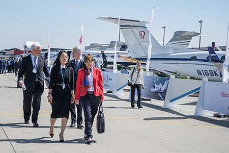 Attendees network and tour the aircraft display of Aircraft at the Geneva Airport on Tuesday during EBACE2019.