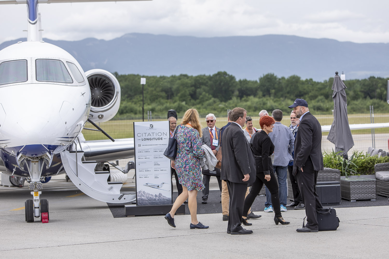Attendees network and explore aircraft at the EBACE2022 display.